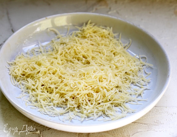 Натереть на мелкой терке пармезан или другой твердый выдержанный сыр. Это важно, так как из обычного полутвердого сыра так легко чипсы не получатся.