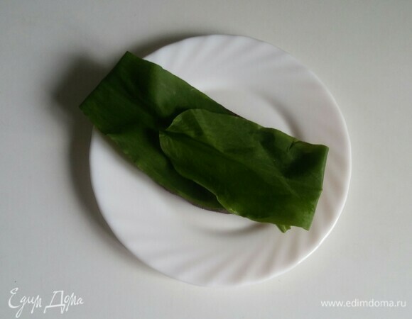 Начинаем собирать тост. На кусок хлеба кладем листики черемши, предварительно оторвав у них ножки, т. к. они не понадобятся.