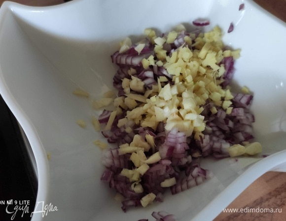 Для соуса очистить лук, имбирь (кусочек размером 3 см) и чеснок, мелко нарезать и отставить в сторону. Достать сердцевину и мелко нарезать перец чили. Листья кинзы сорвать со стеблей (примерно половину пучка, хорошая горсть), мелко нарезать. Остальное отложите в сторону для подачи. Снять листья мяты со стеблей и также мелко нарезать ( около 1 ч. л.).