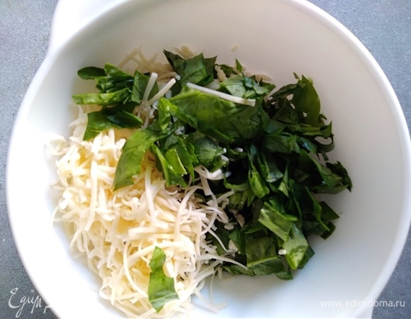 Шпинат промыть, высушить и нарезать. Соединить с тертым сыром.
