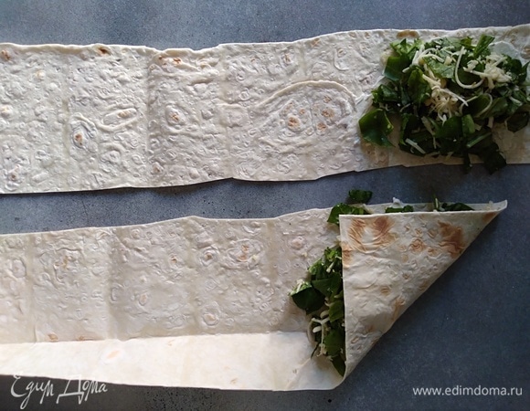 На край лаваша положить начинку и свернуть треугольником.