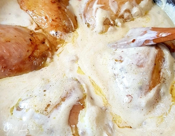 В сметанную заливку выложить бедра, сделать огонь минимальным и тушить под крышкой 30 минут.