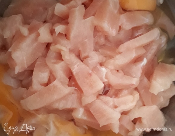 К нарезанному куриному филе добавить 2 яйца. Перемешать.