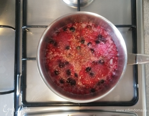 Когда соус закипел, добавить сушеный молотый чеснок. Перемешать. Затем убавить огонь до минимума и варить, помешивая, до загустения соуса. Когда соус загустеет, добавить вино и варить еще около 5–7 минут.