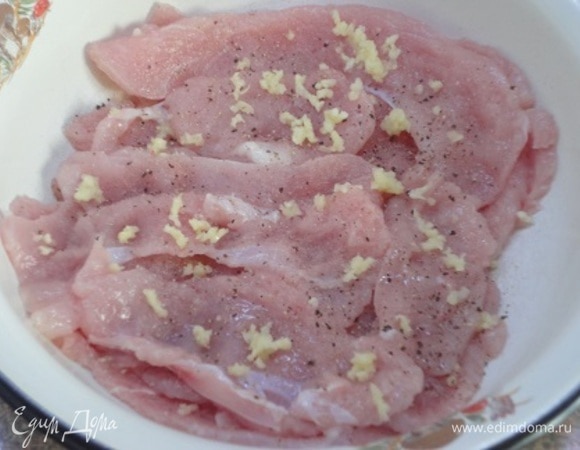 Филе индейки нарезать тонкими полосками. Слегка отбить. Посолить, поперчить, добавить раздавленный чеснок и оставить мариноваться, пока подготавливаете кабачки.