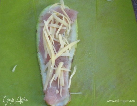 На полоску кабачка выкладываем полоску индейки и посыпаем сыром.