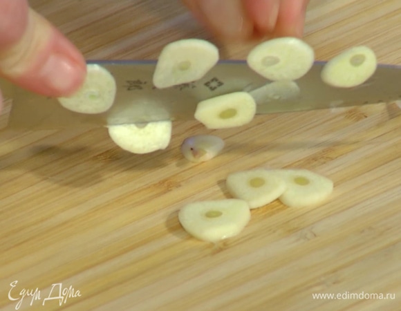 Чеснок почистить, мелко нарезать, добавить к луку и все обжарить.