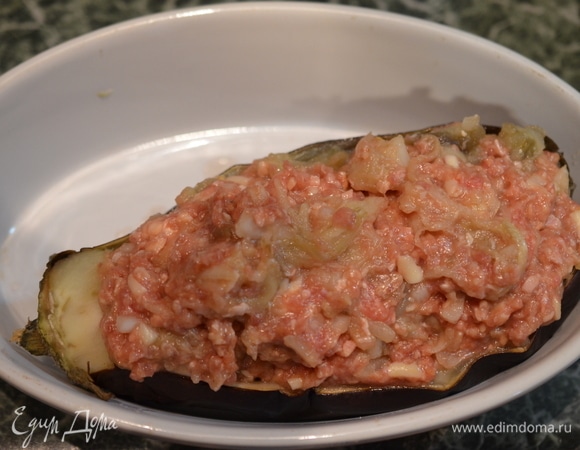 Половинки баклажана начините фаршем и верните в духовку. Запекайте при 180°C около 40 минут.