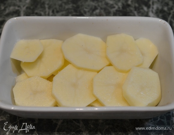 В жаропрочную форму выложите кружки картофеля.