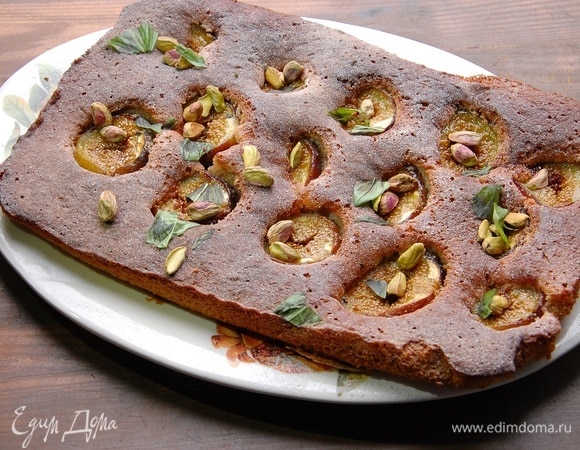 Готовый пирог посыпать сахарной пудрой, оставшимися фисташками и измельченным руками базиликом.