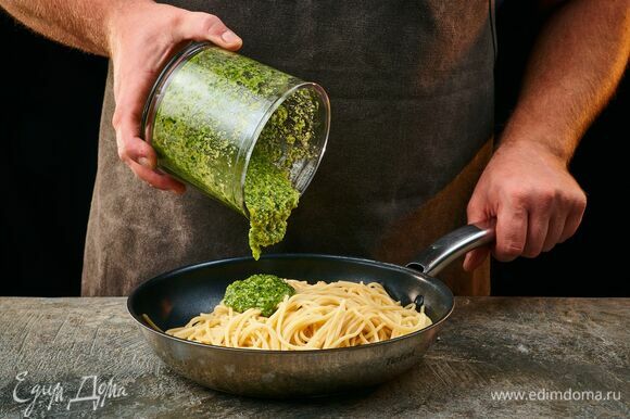 Перемешайте приготовленные спагетти и песто, добавляя воду с пасты по мере необходимости, чтобы получить кремообразную консистенцию.
