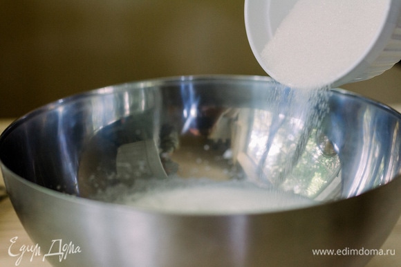 Переложить белки в большую чашу и начать взбивать до пены. Постепенно добавлять сахар, не прекращая взбивать.
