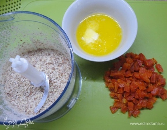 Миндаль измельчить, курагу нарезать, сливочное масло растопить. Муку смешать с крахмалом, солью и разрыхлителем. Включить духовку на 180°C.