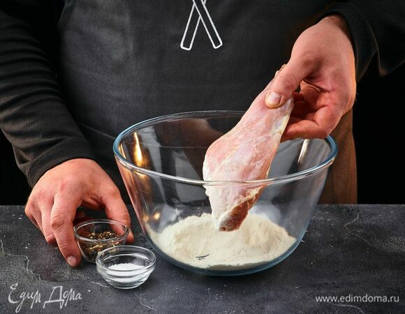 Муку смешайте с солью и перцем. Обваляйте в смеси ножки кролика.