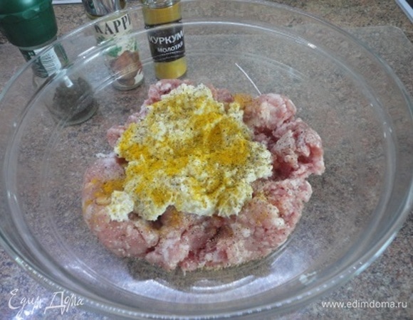 Мясной фарш мы никогда не покупаем, а готовим на мясорубке с крупной решеткой. Соединяем мясо с луком и хлебом. Если молоко не полностью впиталось хлебом, я его выливаю в фарш. Солим, перчим и добавляем пряности по своему вкусу. У меня здесь куркума. Теперь надо хорошо вымесить руками фарш, как тесто, в течение 7–10 минут.