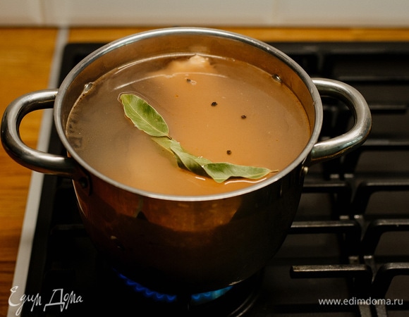 Сварить бульон: в кастрюлю налить воды, добавить рыбу (у меня хребет с филе), а также лавровый лист и черный перец горошком. Довести до кипения, затем варить 20 минут, снимая пену.