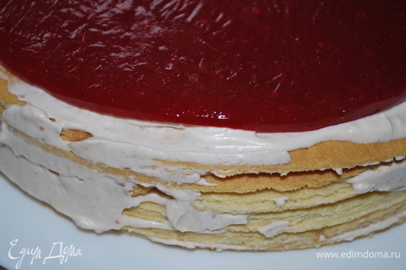 Соберите торт, промажьте коржи кремом. В середину торта выложите малиновый слой и покройте его небольшим количеством крема.