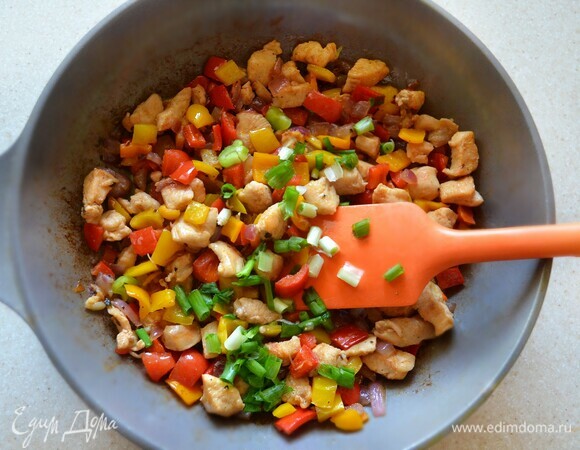 Добавьте в сковороду к куриному филе лук и готовьте еще 5 мин. Затем добавьте болгарский перец, приправьте солью и перцем, готовьте все вместе еще 5 мин.