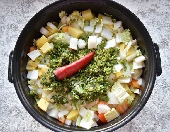 Поочередно добавляю все оставшиеся овощи: картофель, дайкон, болгарский перец, капусту, зелень, чеснок, целый стручок острого перца. Вливаю бульон. По окончании программы «Жарка» включаю режим «Тушение» на 1 час и дожидаюсь сигнала мультиварки о готовности блюда.