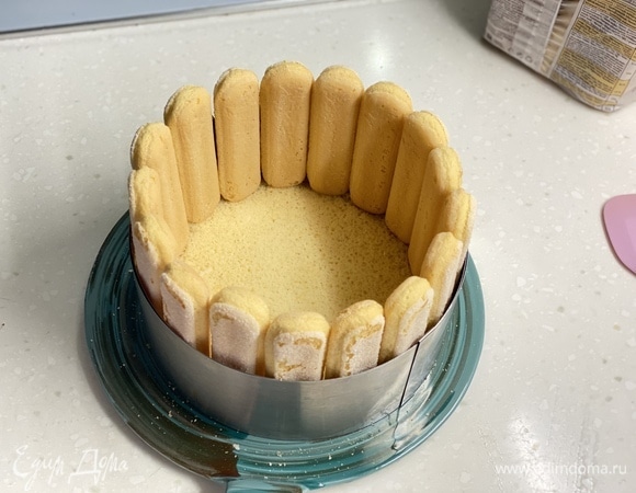 Тесто вылить в разъемную форму диаметром 18 см. Выпекать около 20 минут при 160°C, до пробы на сухую палочку. На дно разъемной формы выложить готовый бисквит, по бокам поставить печенье савоярди.