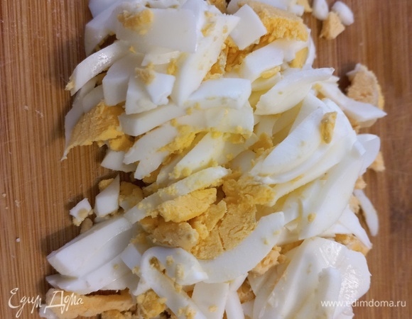 Яйца сварить, очистить и нарезать брусочками или ломтиками.