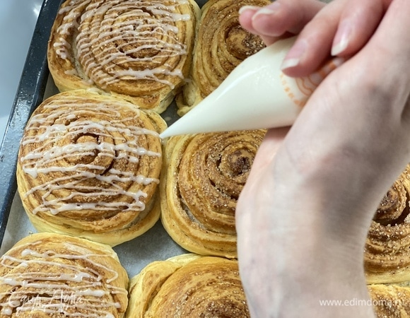 Приготовим глазурь. Смешать в миске сахарную пудру, ванильный экстракт и молоко до полного растворения пудры. Смесь должна слегка загустеть. И полить булочки сверху. Мне было удобнее делать это из кондитерского мешка. Готово!