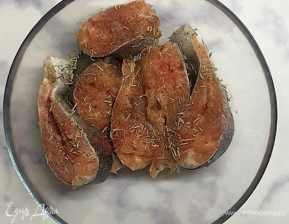 Нарезаем рыбу на стейки или берем готовые. Посыпаем солью и смесью перцев, натираем со всех сторон. Лук нарезаем полукольцами.