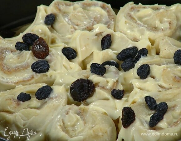 Тесто в форме смазать миндальной пастой и кремом, посыпать изюмом и уложить рулеты срезами вверх. Смазать все оставшимся кремом и посыпать изюмом, накрыть форму влажным полотенцем и оставить на 20–30 минут.