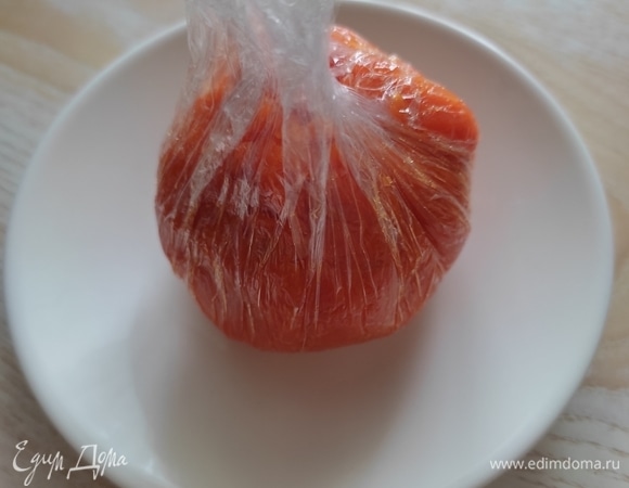 Аккуратно собрать края пленки к центру, чтобы морковь закрыла со всех сторон салатик.