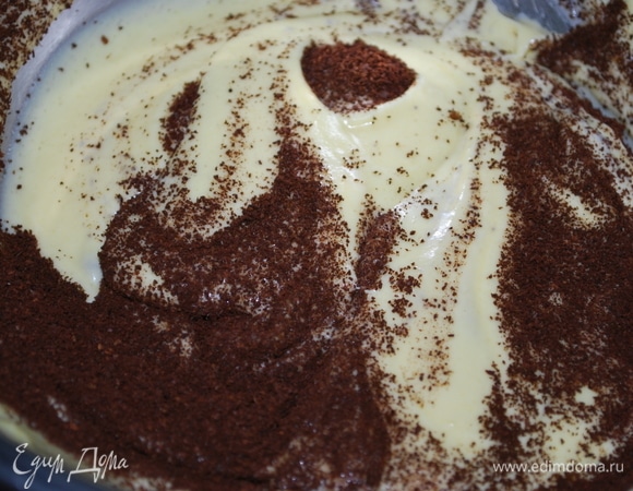 Не прекращая взбивать, добавьте сметану и молотый зерновой кофе. Хорошо подойдет кофе крупного помола, за счет крупных зерновых крупинок текстура у печенья будет более выражена.