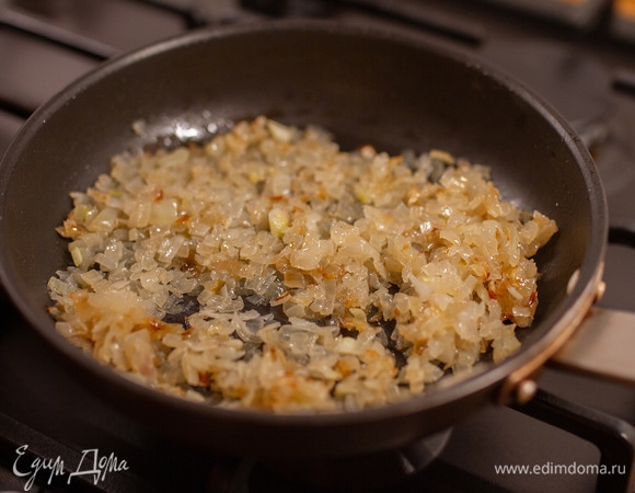 Лук очистить и мелко нарезать. В сковороде растопить оставшееся сливочное масло и, помешивая, обжарить на нем лук до золотистого цвета.