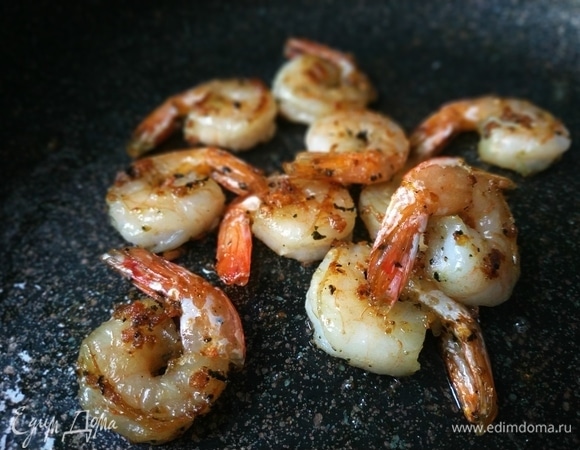 Креветки очистите от панцирей и кишок, если это необходимо. Чеснок очистите и мелко порубите. Сковороду с толстым дном разогрейте, налейте растительное масло и обжарьте креветки с чесноком в течение 3–4 минут, поперчите по вкусу.