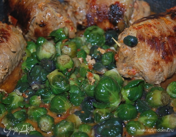 Брюссельскую капусту отварите в кипящей воде в течение 1 минуты, откиньте на дуршлаг, чтобы стекла вода. Добавьте капусту к рулетам и прогревайте вместе 2–3 минуты, капуста напитается ароматом соуса. При подаче капусту посыпьте сыром. Подавайте к столу.