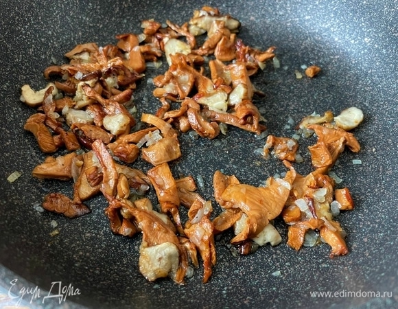 Лук очистите и мелко порубите. Сковороду с толстым дном разогрейте, налейте оливковое масло, добавьте лук и обжаривайте все в течение 2–3 минут. Добавьте нарезанные лисички (у меня замороженные и предварительно отваренные). Можно добавить грибы, которые вы любите. Обжаривайте лук с грибами в течение 5–6 минут.