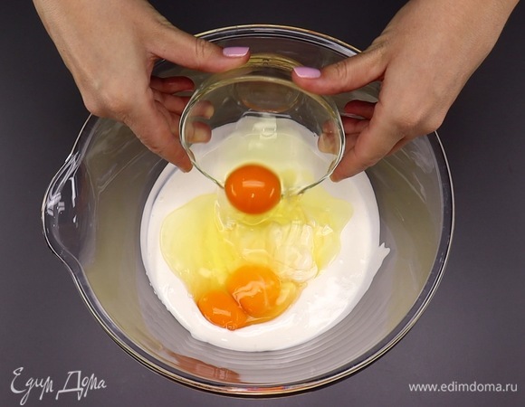 Теперь к сметане добавляем 100 г майонеза, вбиваем 3 яйца и щепотку соли. Тщательно перемешиваем венчиком.