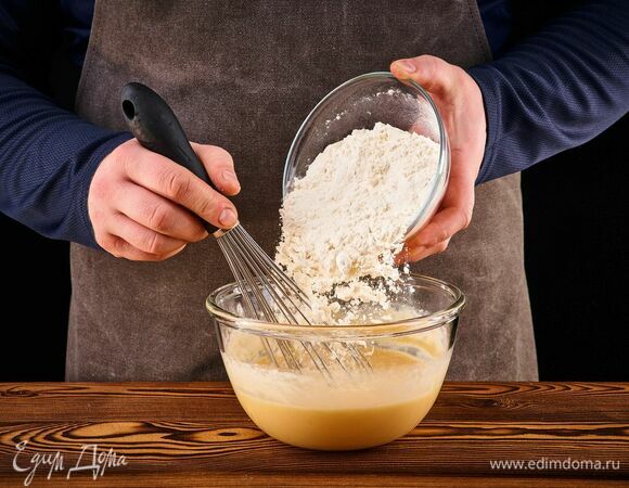 Просейте муку в чашу. Тщательно перемешайте массу венчиком, чтобы не было комочков.<br />
Влейте оставшееся молоко. Блинное тесто должно получиться жидким, как жирные сливки.<br />
 