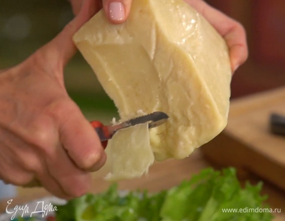 Сыр при помощи овощечистки нарезать тонкими хлопьями.