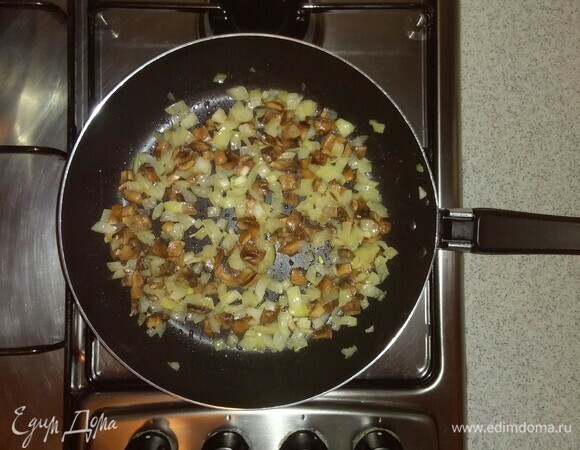 Затем добавить к луку нарезанные шампиньоны. Перемешать и обжариваем овощи еще 3 минуты.