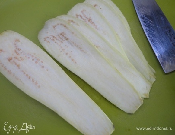 Разогрейте духовку до 180°C. Баклажаны нарежьте пластинками толщиной примерно 5 мм.