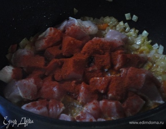 Лук порубить мелко и в кастрюле для тушения пассеровать до золотистого цвета. Перец нарезать соломкой, добавить к луку и перемешать. Через пару минут добавить мясо, нарезанное крупными кубиками (примерно 2х2 см), а после добавить томатную пасту. Паприку высыпать на мясо, дать ей прогреться пару минут и только потом перемешать, чтобы приправа не подгорела и не горчила.