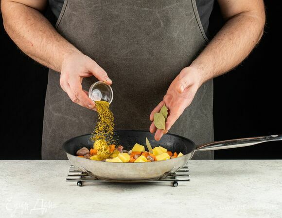 Нарежьте картофель, добавьте к потрошкам. Всыпьте хмели-сунели и положите лавровый лист.