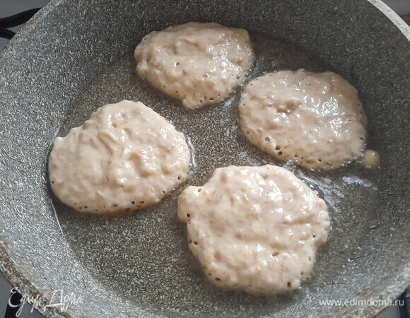 В сковороде разогреть растительное масло. Столовой ложкой выложить оладьи круглой или овальной формы. Обжарить сначала с одной стороны.