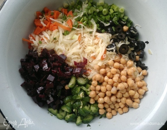 В миске соединить все подготовленные продукты: нут, свеклу, морковь, малосольные огурцы, лук, оливки, капусту. Овощи перемешать, по вкусу подсолить (если нужно), поперчить. Заправить ароматным подсолнечным маслом, еще раз перемешать.