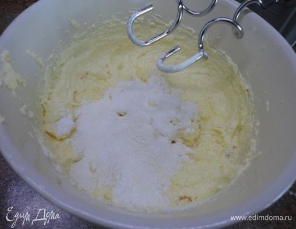 Муку смешать с крахмалом и разрыхлителем и порциями просеять к масляной смеси, каждый раз тщательно перемешивая.