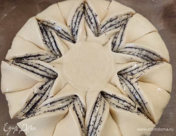 Сверху на пирог поставить стакан, от него к краю сделать разрезы, 16 штук. Развернуть лепестки друг к другу, смазать пирог сверху яйцом. Выпекать 30 минут при температуре 200°C.