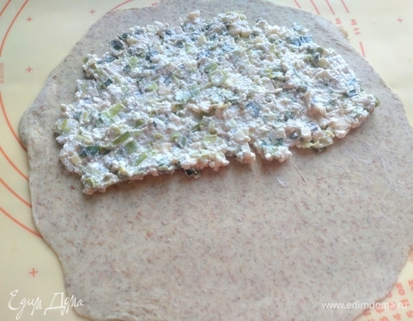 Раскатать тонко каждую часть теста и распределить поровну начинку.