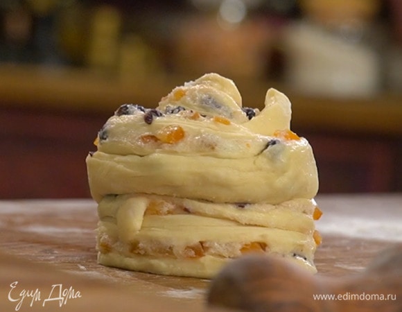 Каждую часть раскатать в прямоугольник, смазать сливочно-фруктовой смесью, свернуть по длинной стороне в рулет и разрезать его вдоль не до конца, затем одну полоску свернуть улиткой фруктами наружу и обернуть сверху второй полоской также фруктами наружу.