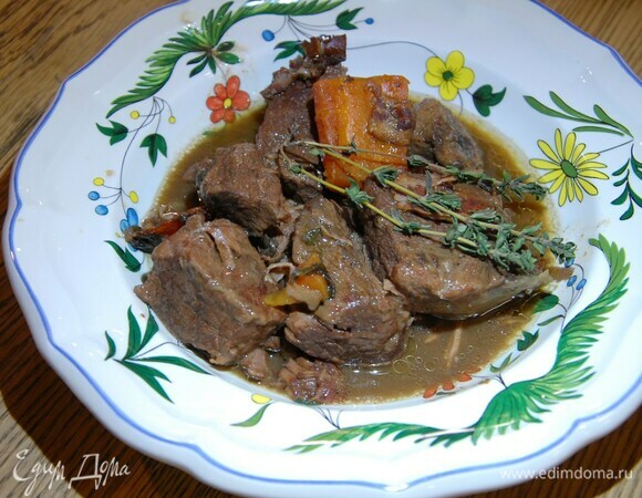 Разогреть в чаше мульти-кухни оливковое масло и обжарить мясо со всех сторон, затем добавить морковь, шалот, тимьян, петрушку и бекон, влить красное вино и бульон, так чтобы мясо было покрыто, выставить программу «тушение» и томить два часа.