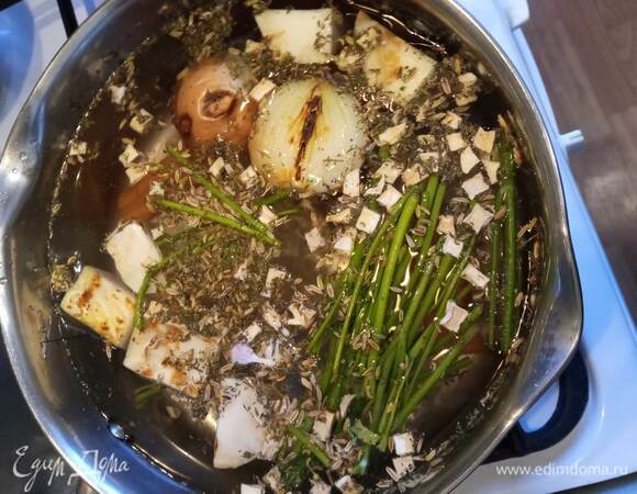 В кастрюлю кладу стебли укропа и петрушки, добавляю сухой корень петрушки и розмарин, подпеченные овощи и заливаю горячей водой. Когда вода закипит, уменьшаю огонь и варю бульон 40 минут. Процеживаю.