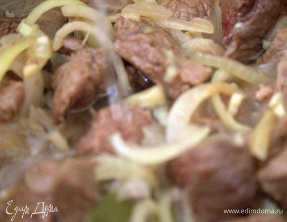 Когда мясо обжарится, всыпать лук.